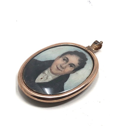 198 - An antique 9 carat gold framed locket pendant;  with a rounded glass holding a finely hand painted s... 