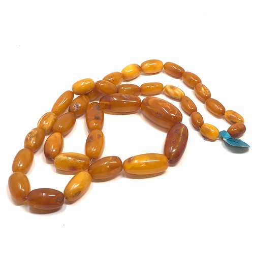 97 - An antique butterscotch / egg yolk amber bead necklace, weight  Approx. 58.7 grams.