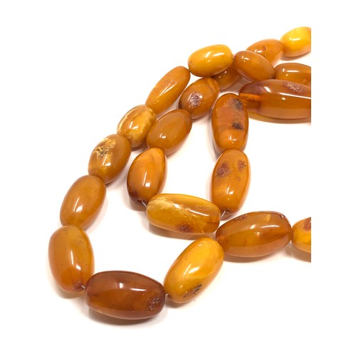 97 - An antique butterscotch / egg yolk amber bead necklace, weight  Approx. 58.7 grams.