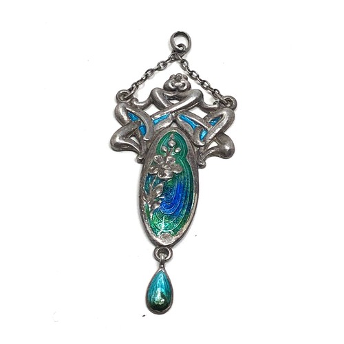 110 - An antique silver pendant, with  Art Nouveau floral designs decorated with blue &  green enamelling.... 