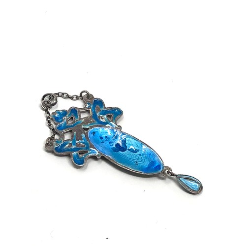 110 - An antique silver pendant, with  Art Nouveau floral designs decorated with blue &  green enamelling.... 