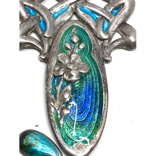 110 - An antique silver pendant, with  Art Nouveau floral designs decorated with blue &  green enamelling.... 