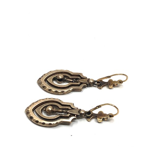 144 - A pair of antique 9ct  gold  earrings, with hinged wires, seed pearls set to the tops and articulate... 