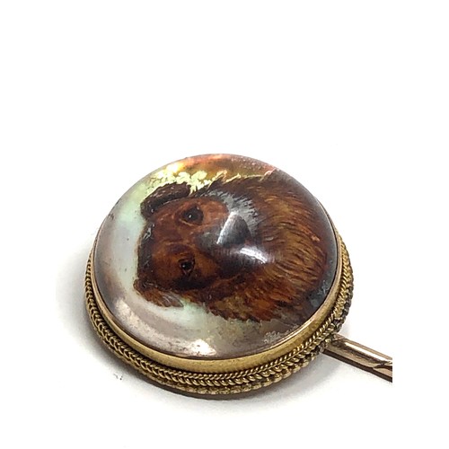 88 - An antique 15ct gold essex crystal stickpin set with a hand carved Essex crystal reverse-painted hig... 