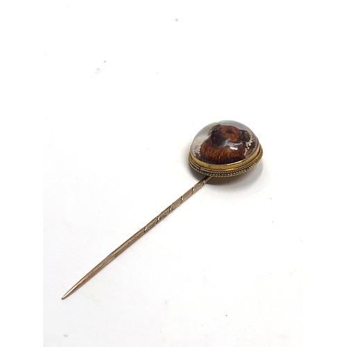 88 - An antique 15ct gold essex crystal stickpin set with a hand carved Essex crystal reverse-painted hig... 