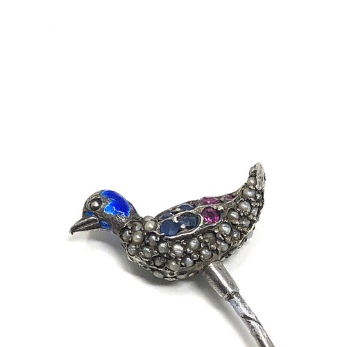 150 - An antique silver stickpin, topped with a duck decorated with blue enamel and pave set with seed pea... 