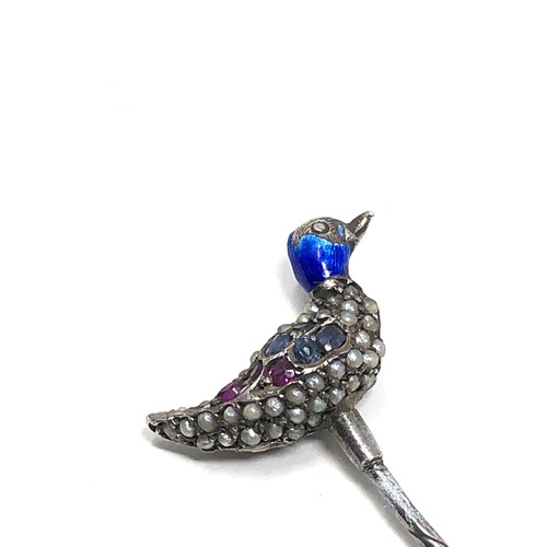 150 - An antique silver stickpin, topped with a duck decorated with blue enamel and pave set with seed pea... 