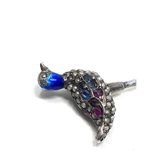 150 - An antique silver stickpin, topped with a duck decorated with blue enamel and pave set with seed pea... 