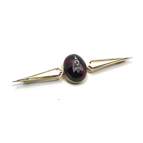 112 - An antique 15ct gold cabochon garnet & rose diamond bug brooch measures 76 mm long: Approx. 8.1 gram... 