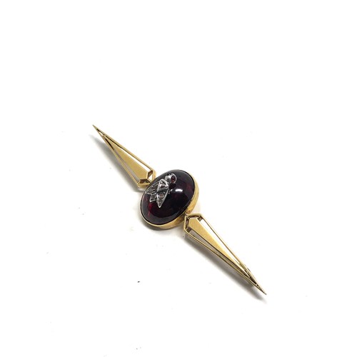 112 - An antique 15ct gold cabochon garnet & rose diamond bug brooch measures 76 mm long: Approx. 8.1 gram... 