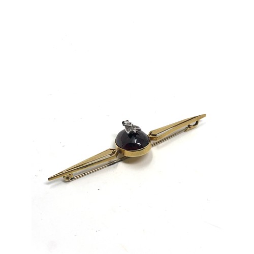 112 - An antique 15ct gold cabochon garnet & rose diamond bug brooch measures 76 mm long: Approx. 8.1 gram... 