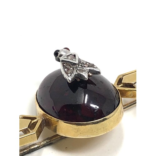 112 - An antique 15ct gold cabochon garnet & rose diamond bug brooch measures 76 mm long: Approx. 8.1 gram... 