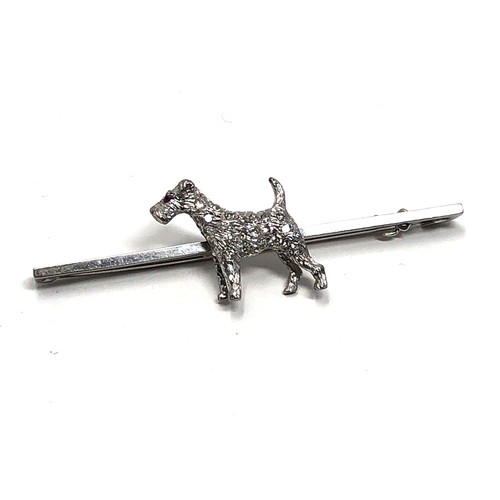 120 - An antique 15 ct white gold & 18ct white gold & diamond fox terrier bar brooch;   set throughout wit... 