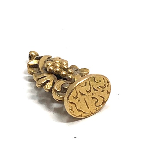 186 - Heavy antique high carat gold islamic fob, with entwined grape vine body and inscribed to the base w... 