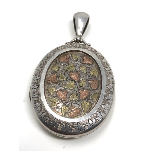 196 - An antique  silver locket, decorated with applied rose &  yellow gold flowers measures approx 47 x 3... 