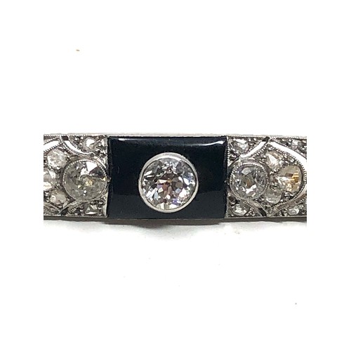 176 - Fine antique platinum onyx & diamond brooch; , set with chunky old cut diamonds surrounded by tiny r... 