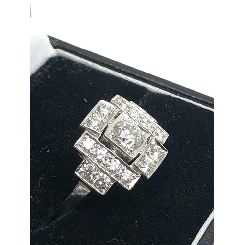 156 - An Art Deco style platinum diamond ring; white diamonds in geometric millegrain settings. Stamped 'P... 