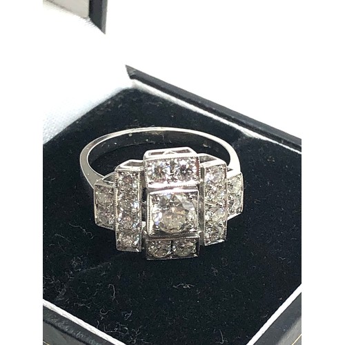 156 - An Art Deco style platinum diamond ring; white diamonds in geometric millegrain settings. Stamped 'P... 