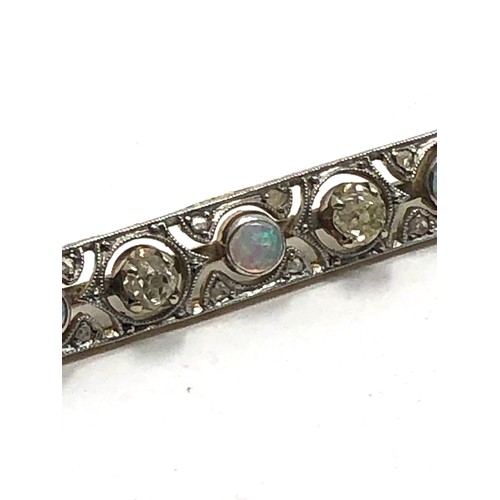 153 - An antique 18 carat gold opal & diamond bar brooch set with alternating opals &  old cut diamonds su... 