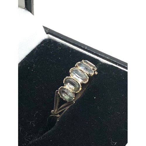 192 - An antique georgian gold ring, set with a row of foiled rock crystals.