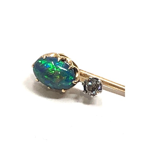 177 - An antique 15 carat gold black opal & old cut diamond stickpin, opal approx 8 x 6 mm, 2.4 inches lon... 