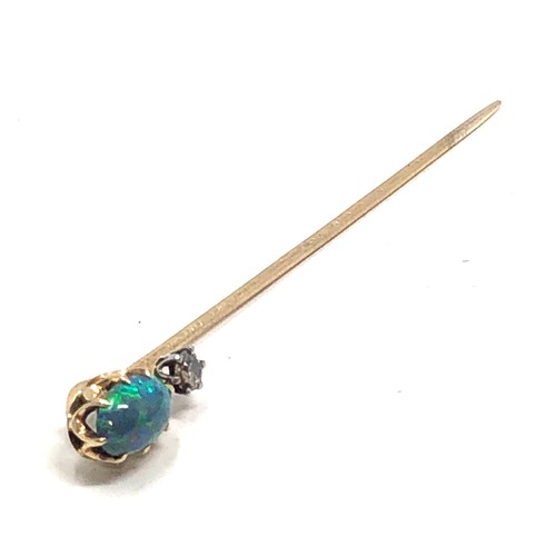 177 - An antique 15 carat gold black opal & old cut diamond stickpin, opal approx 8 x 6 mm, 2.4 inches lon... 