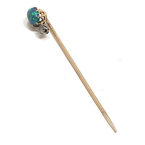 177 - An antique 15 carat gold black opal & old cut diamond stickpin, opal approx 8 x 6 mm, 2.4 inches lon... 