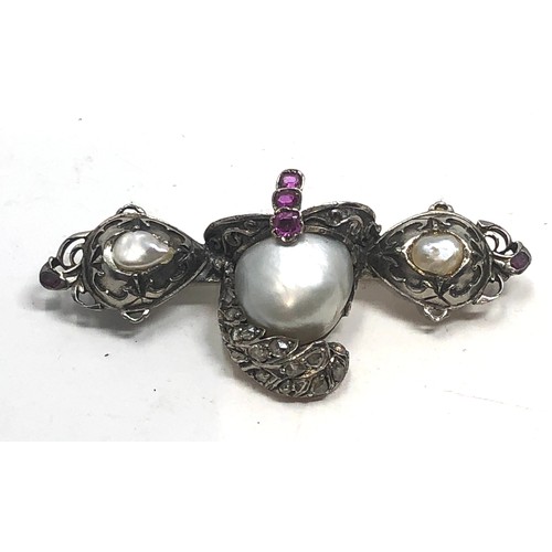 139 - Antique silver ornate helmet brooch, set with pearls,  rose cut diamonds and  rubies. measures appro... 