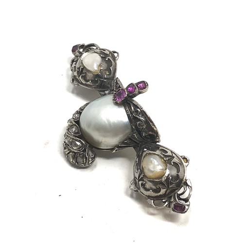 139 - Antique silver ornate helmet brooch, set with pearls,  rose cut diamonds and  rubies. measures appro... 