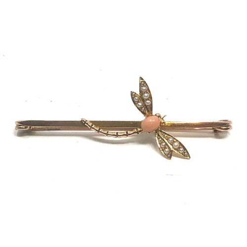 114 - An antique 9 carat gold coral & pearl dragonfly brooch; 67 mm long . 5.6 grams.