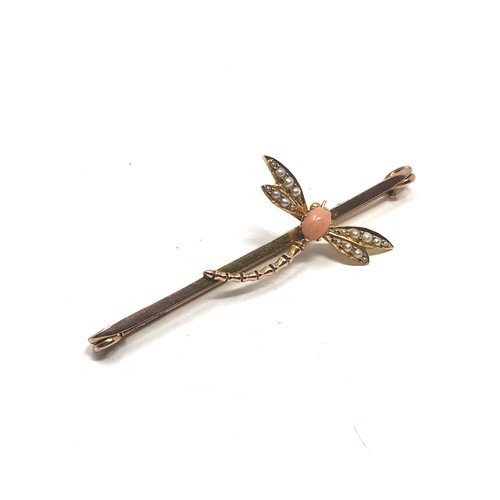 114 - An antique 9 carat gold coral & pearl dragonfly brooch; 67 mm long . 5.6 grams.