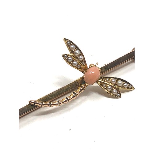 114 - An antique 9 carat gold coral & pearl dragonfly brooch; 67 mm long . 5.6 grams.