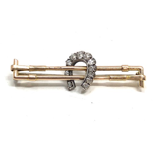 164 - Fine antique gold & diamond horseshoe & riding crop brooch measures approx 4.6cm wide weight 4.3g