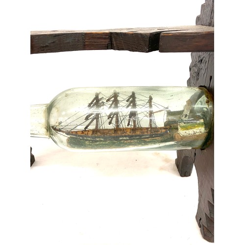 11 - Tramp art Galleon ship in glass bottle mounted on carved wooden stand