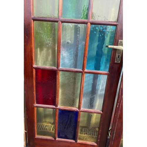 557 - 2 Vintage stained glass doors with side panels, approximate measurements: Length 125 inches, Height ... 