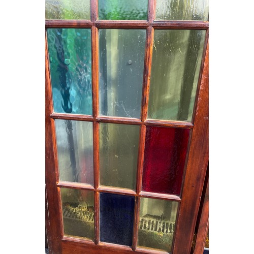 557 - 2 Vintage stained glass doors with side panels, approximate measurements: Length 125 inches, Height ... 