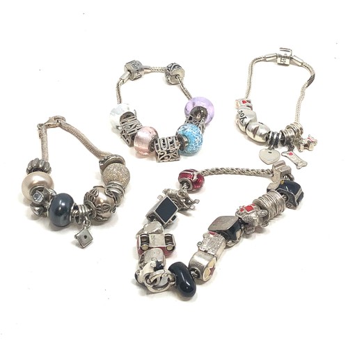 343 - 4 silver mixed brand charm bracelets & charms