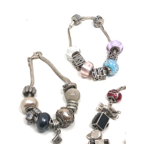 343 - 4 silver mixed brand charm bracelets & charms