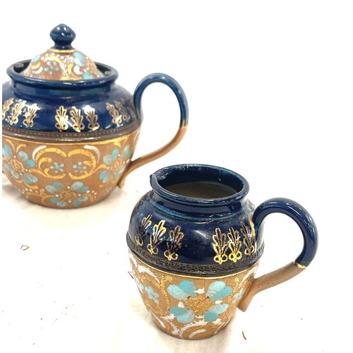110 - Antique Royal Doulton Lambeth teapot, 2 milk jugs, good overall condition