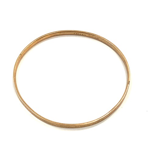 557 - 9ct slave bangle, metal core