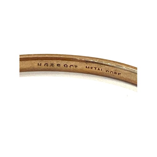 557 - 9ct slave bangle, metal core