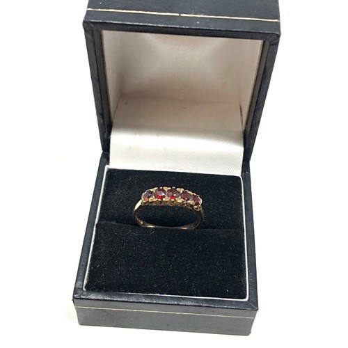 115 - 9ct gold garnet dress ring weight 2.2g