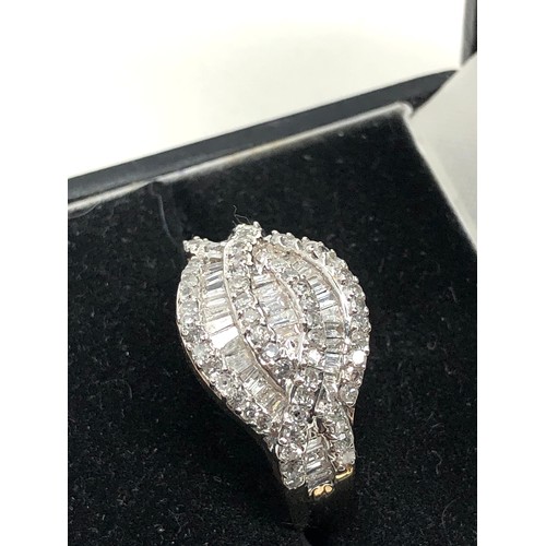 121 - 9ct gold Diamond cluster ring set with rows of baquette diamond with halo of round diamonds est weig... 