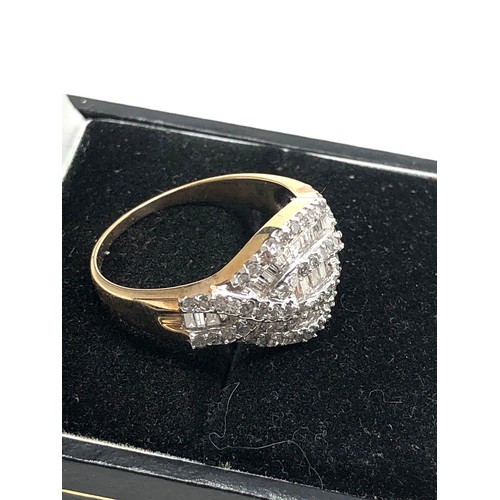 121 - 9ct gold Diamond cluster ring set with rows of baquette diamond with halo of round diamonds est weig... 