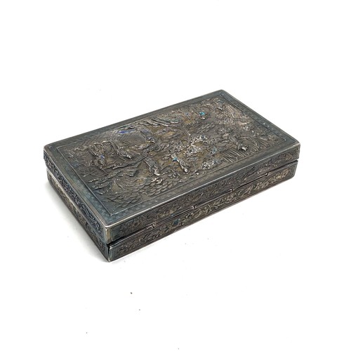43 - Antique chinese repousse silver box measures approx 12.8cm by 7.6cm 2.3cm deep the box show some ena... 