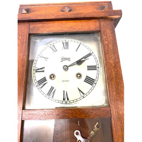 123 - 2 Key hole oak cased wall clock with key pendulum etc