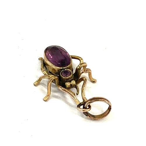 539 - Antique unmarked yellow metal spider pendant set with purple stones