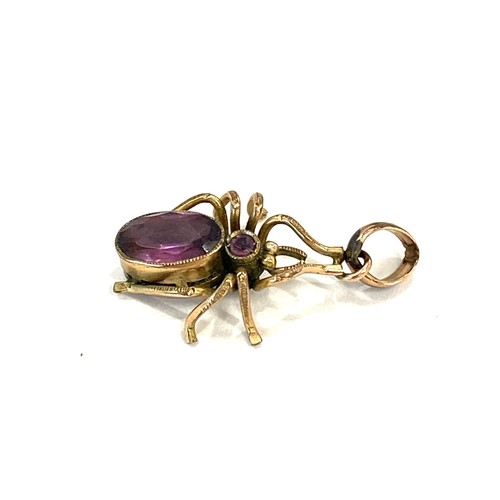 539 - Antique unmarked yellow metal spider pendant set with purple stones