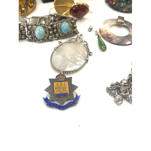 599 - Large selection of vintage and later costume jewellery includes silver pendant and badge