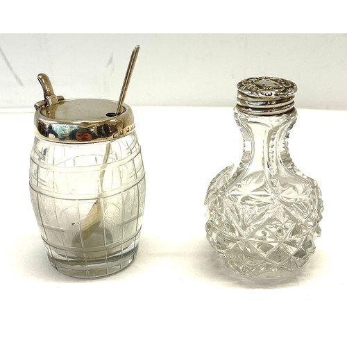 534 - Silver-rimmed condiments jar with silver spoon and a silver-topped salt shaker.